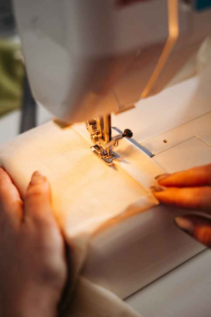 person sewing a fabric